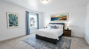 Primary Bedroom with light colored carpet and baseboards