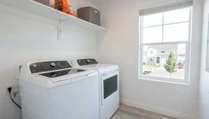 Laundry room with light wood-style floors