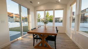 Dining area featuring light wood-type flooring, plenty of natural light, recessed lighting, and lofted ceiling