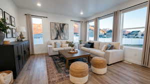 Living area featuring light wood-type flooring and recessed lighting