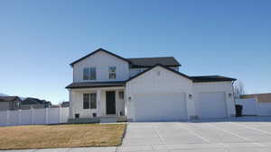 Modern inspired farmhouse featuring board and batten siding, a porch, a garage, and driveway