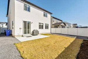 Back of property featuring a patio area, a fenced backyard, stucco siding, and entry steps