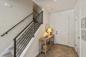 Entryway featuring a textured ceiling and dark wood finished floors