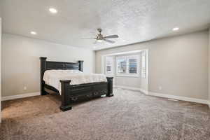 Bedroom with recessed lighting, carpet, a textured ceiling, and a ceiling fan
