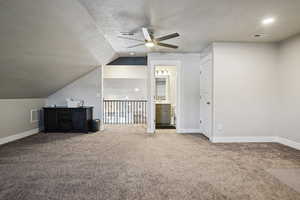 Bonus room featuring a ceiling fan and carpet floors