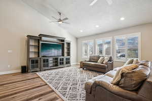 Living area with a ceiling fan, wood finished floors, and recessed lighting