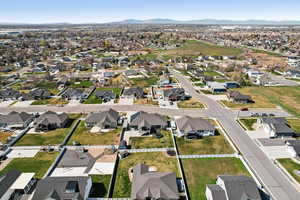 Aerial view of property and surrounding area featuring nearby suburban area