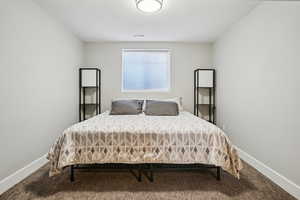 Bedroom with carpet flooring and a textured ceiling