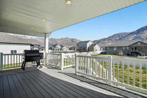 Wooden deck with a residential view, grilling area, and a mountain view