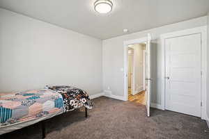 Bedroom featuring light carpet and a textured ceiling