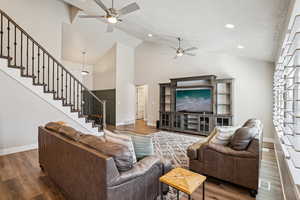 Living room featuring a ceiling fan, wood finished floors, recessed lighting, and a high textured ceiling