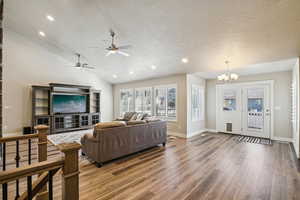 Living area featuring hanging lights, wood finished floors, and a ceiling fan