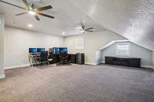 Carpeted home office with baseboards and a ceiling fan