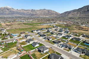 Aerial overview of property's location featuring nearby suburban area and a mountainous background