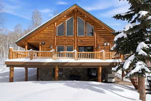 Snow covered house with stone siding