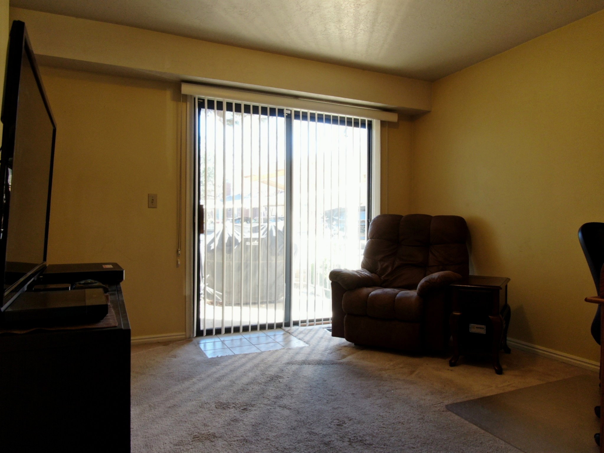 Living area with light carpet and baseboards