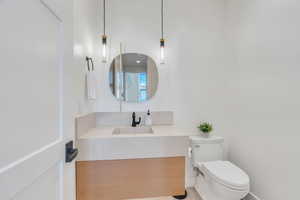 Half bathroom featuring toilet and vanity