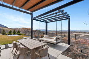 Fenced backyard with a pergola, a mountain view, outdoor dining area, and a patio