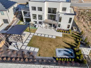 Rear view of house featuring stucco siding and a patio area
