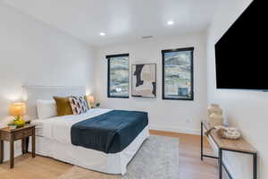 Bedroom with light wood-style floors and recessed lighting