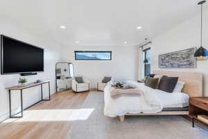 Bedroom with light wood-style floors and recessed lighting