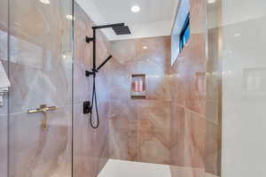 Bathroom with a marble finish shower