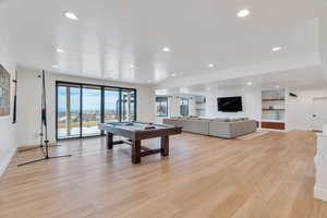 Game room featuring pool table, light wood finished floors, recessed lighting, and built in shelves