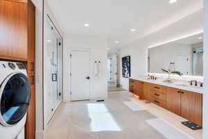 Laundry area featuring washer / dryer, recessed lighting, and light tile patterned floors
