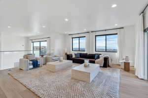 Living room featuring light wood finished floors and recessed lighting