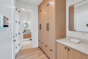 Corridor featuring light wood-style flooring