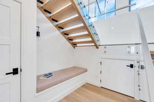 Foyer with light wood finished floors and stairs