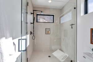 Full bath featuring a shower stall