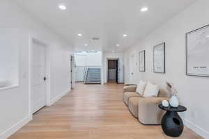 Living room featuring light wood finished floors and recessed lighting