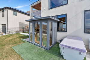 Rear view of property featuring a balcony and a patio