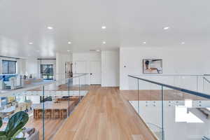 Hallway featuring light wood-style floors and recessed lighting