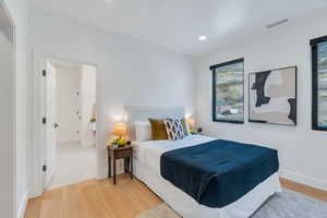 Bedroom with light wood-style floors and recessed lighting