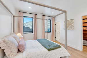 Bedroom with light wood-style flooring, recessed lighting, and multiple windows