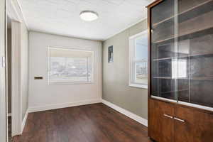 Hall with dark wood finished floors and wooden walls