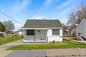 Bungalow with a front yard and a porch