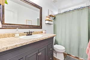 Full guest bathroom with vanity and curtained shower