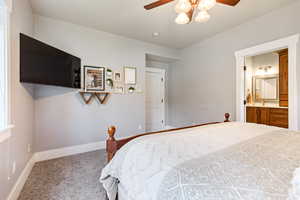 Master bedroom with baseboards and a ceiling fan