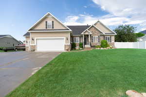 Craftsman inspired home featuring stone siding, driveway, board and batten siding, and an attached garage