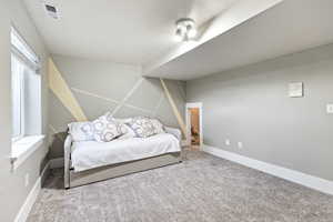 Carpeted bedroom featuring baseboards