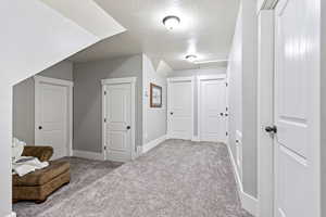 Second floor Interior space featuring a textured ceiling and light colored carpet