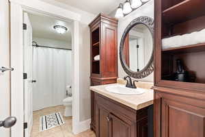 Bathroom featuring vanity, a shower with curtain, and light tile patterned floors