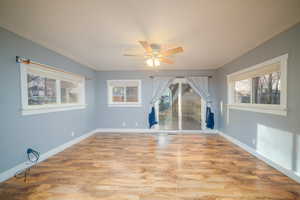 Dining area with light wood-style floors and ceiling fan