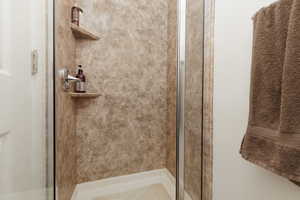 Full bathroom with a shower stall