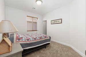 Bedroom featuring baseboards and light colored carpet