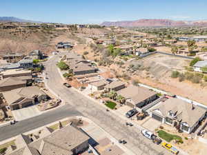 Aerial view of property's location featuring nearby suburban area and mountains