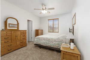 Bedroom with light colored carpet and a ceiling fan